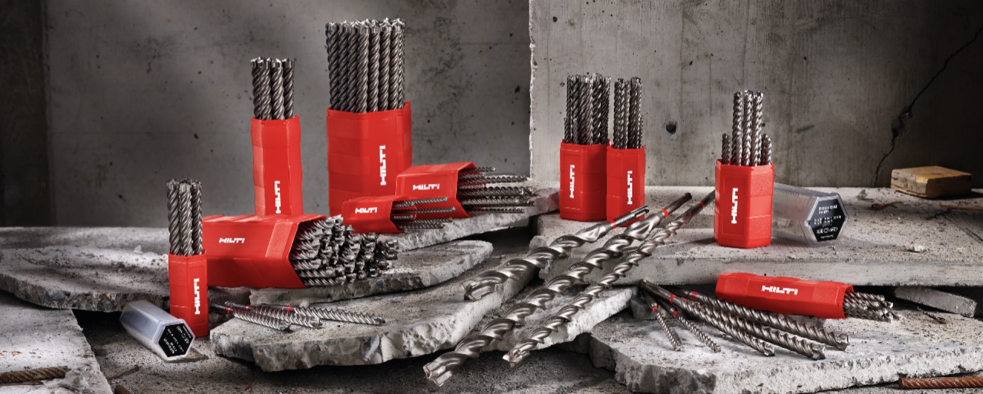 A collection of TE CX drill bits placed atop a mound of rubble